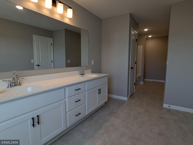 6752 104th St, Cottage Grove, MN 55016 - bathroom with double vanity, baseboards, and recessed lighting