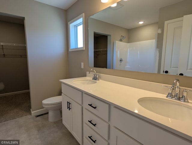 6752 104th St, Cottage Grove, MN 55016 - full bath with a shower, a walk in closet, double vanity, toilet, and baseboards
