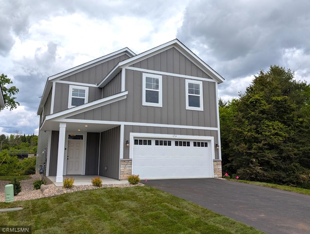 6752 104th St, Cottage Grove, MN 55016 - view of front of house with driveway, board and batten siding, an attached garage, and stone siding
