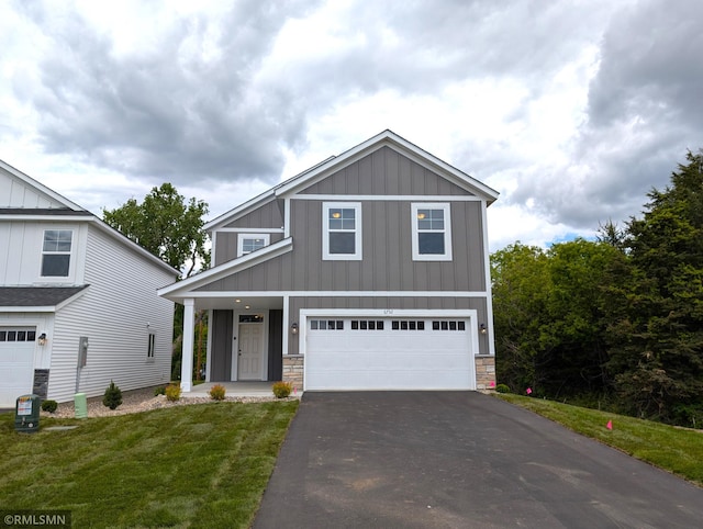 6752 104th St, Cottage Grove, MN 55016 - view of front facade with board and batten siding, driveway, a front lawn, a garage, and stone siding