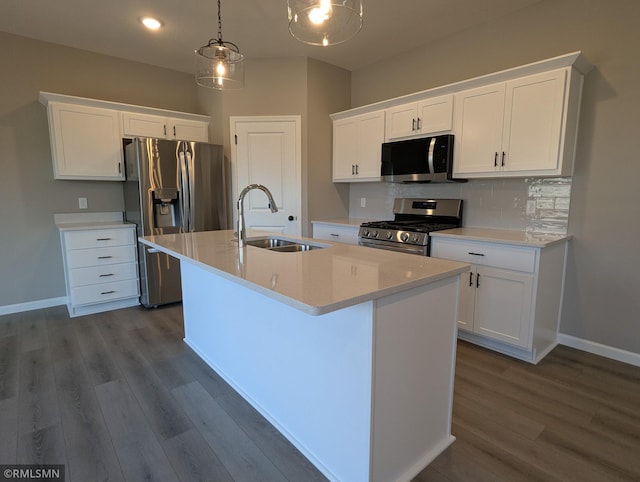 6752 104th St, Cottage Grove, MN 55016 - kitchen featuring appliances with stainless steel finishes, a sink, dark wood finished floors, an island with sink, and white cabinets