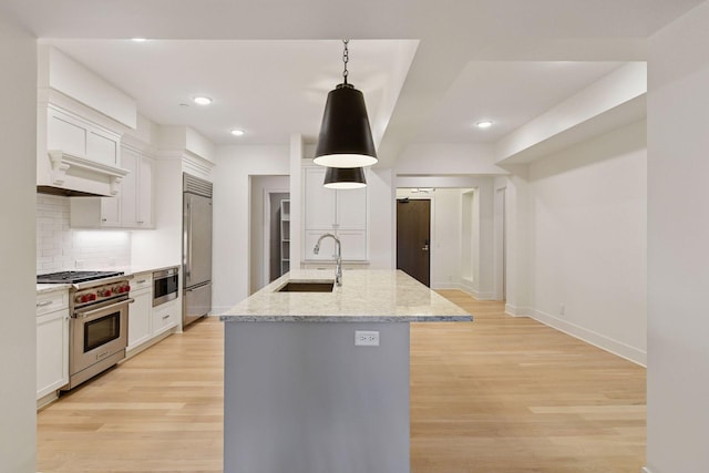 222 Ferndale Rd S Unit 207, Wayzata, MN 55391 - kitchen featuring high end appliances, decorative backsplash, white cabinetry, light wood-type flooring, and recessed lighting