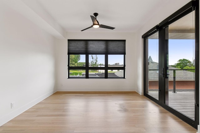 222 Ferndale Rd S Unit 207, Wayzata, MN 55391 - spare room with light wood finished floors, a ceiling fan, and french doors