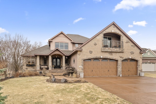 view of front of home with roof with shingles, a balcony, an attached garage, french doors, and concrete driveway