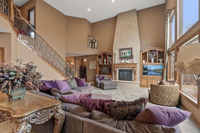 living room with recessed lighting, a towering ceiling, and stairs