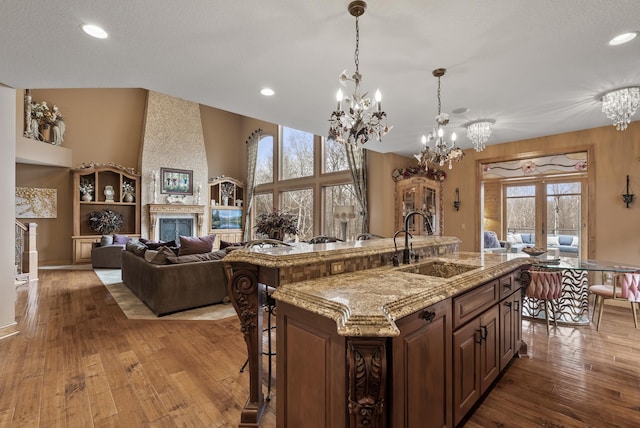 kitchen with a chandelier, wood-type flooring, french doors, and a sink