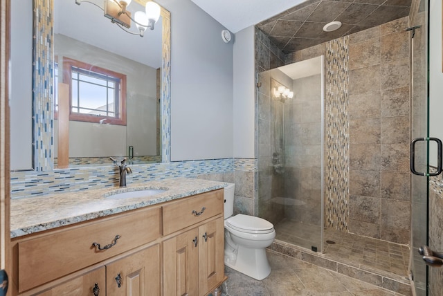 full bathroom featuring tile patterned floors, toilet, a stall shower, and vanity