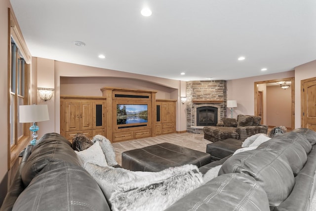 living area featuring a large fireplace and recessed lighting