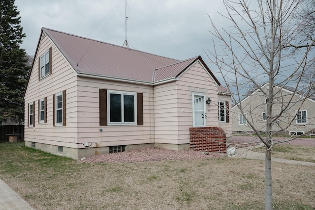 bungalow-style house with a front lawn and metal roof