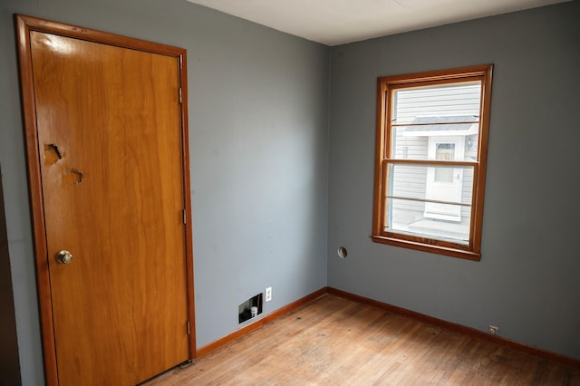 empty room with baseboards and light wood finished floors