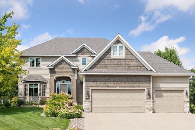 craftsman house featuring driveway, a front lawn, and an attached garage