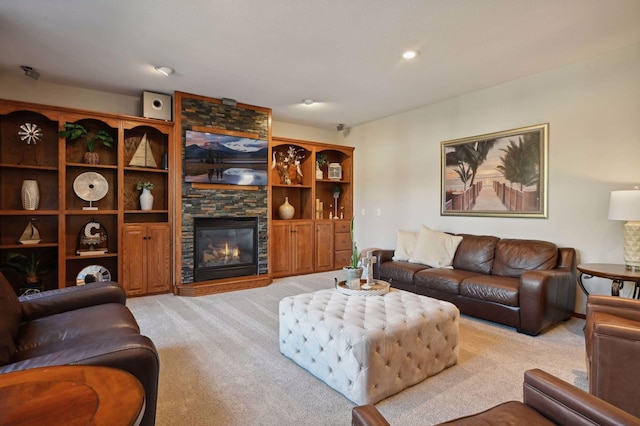 living room featuring light carpet and a stone fireplace
