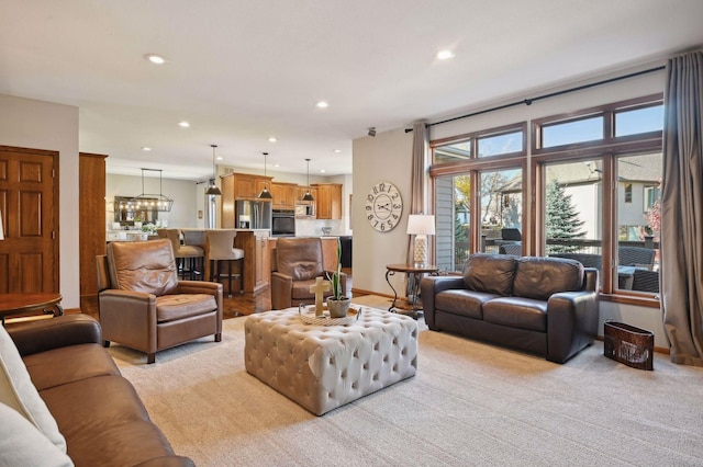 living room with baseboards, recessed lighting, and light carpet