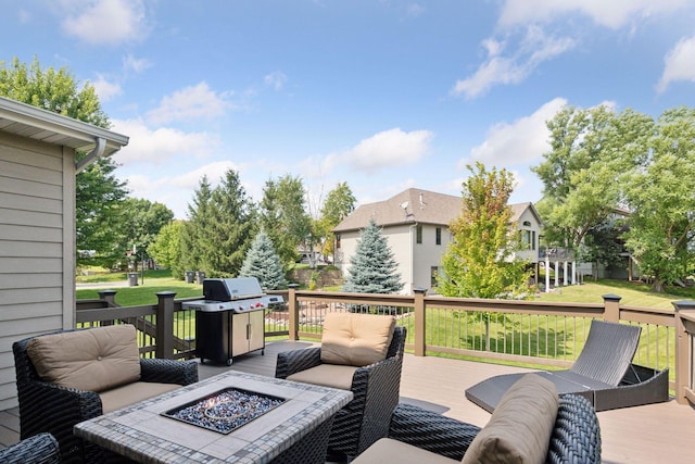 deck featuring a fire pit, grilling area, and a yard