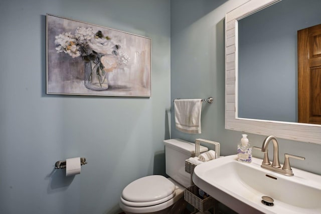 bathroom featuring toilet and a sink