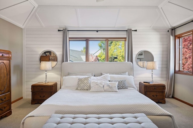 bedroom with baseboards, wood walls, lofted ceiling, and carpet