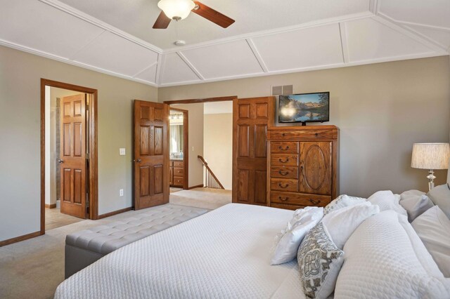bedroom with ensuite bath, light carpet, baseboards, visible vents, and lofted ceiling