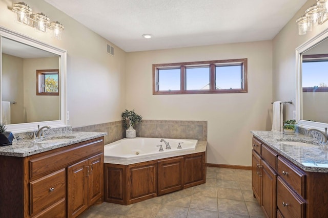 bathroom with visible vents, two vanities, and a sink