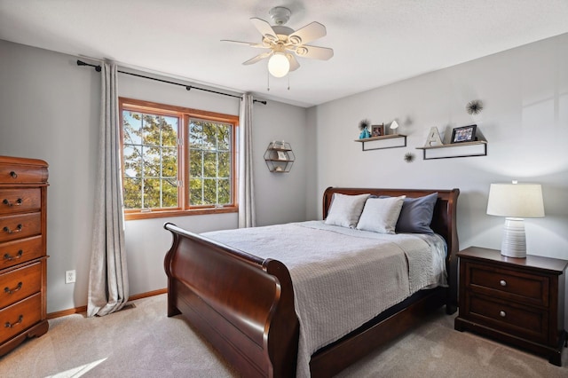 bedroom with ceiling fan, baseboards, and light carpet