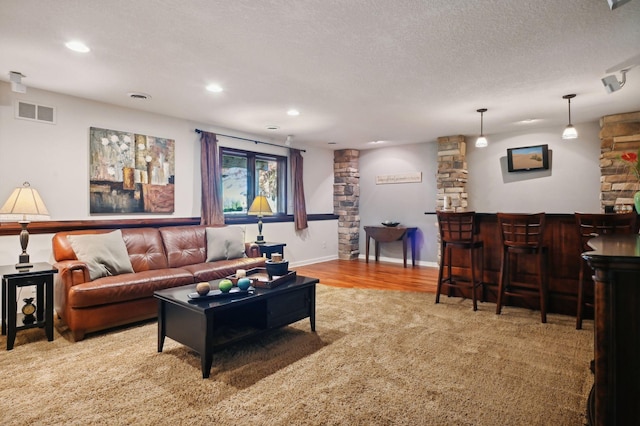 living area with visible vents, decorative columns, carpet flooring, and recessed lighting