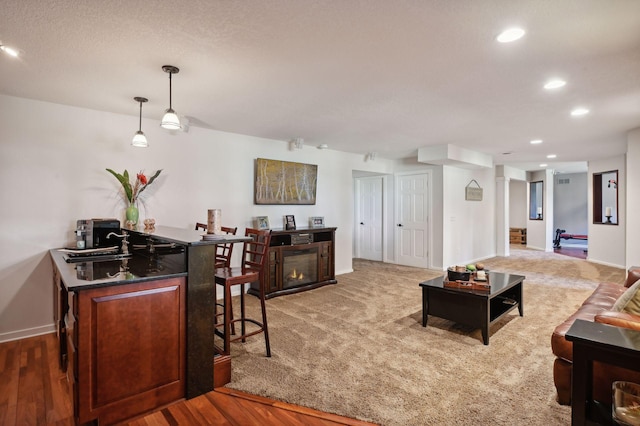 living area with baseboards, recessed lighting, and wood finished floors