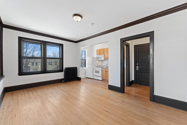 2218 Nicollet Ave Unit 22, Minneapolis, MN 55404 - unfurnished living room featuring radiator, crown molding, light wood-style floors, and baseboards