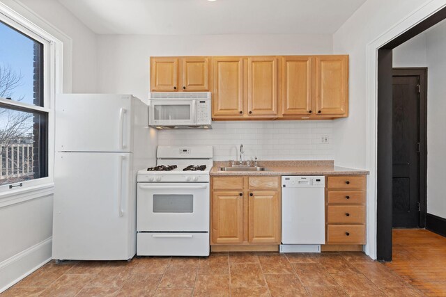 2218 Nicollet Ave Unit 22, Minneapolis, MN 55404 - kitchen with light countertops, white appliances, backsplash, a sink, and light brown cabinets
