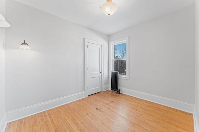 2218 Nicollet Ave Unit 22, Minneapolis, MN 55404 - spare room with radiator, baseboards, and hardwood / wood-style floors