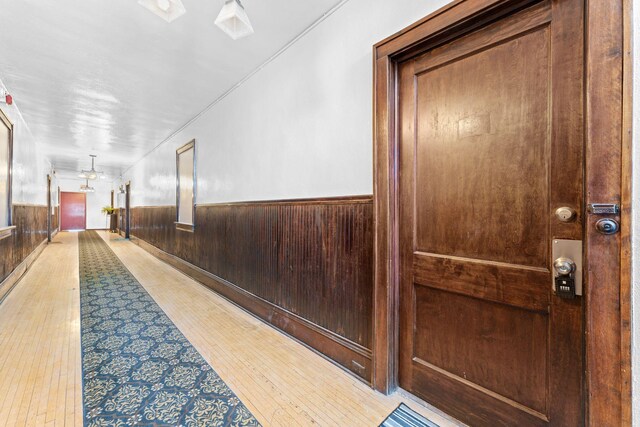 2218 Nicollet Ave Unit 22, Minneapolis, MN 55404 - hallway with light wood-type flooring, wooden walls, and wainscoting