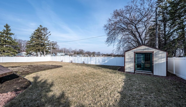 view of yard with a fenced backyard, an outdoor structure, and a shed