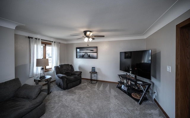 carpeted living room featuring a ceiling fan and baseboards