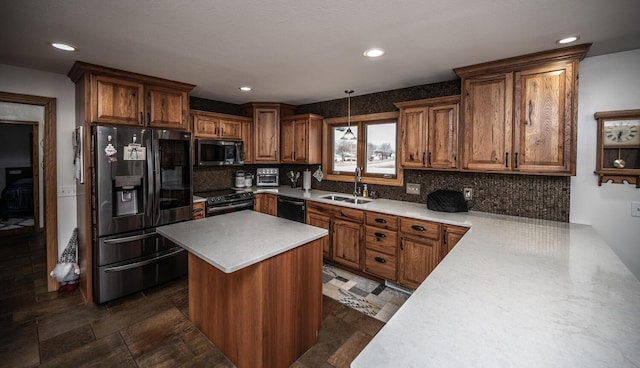 kitchen with a center island, a sink, decorative backsplash, light countertops, and appliances with stainless steel finishes