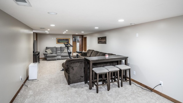 living area featuring baseboards, visible vents, carpet floors, and recessed lighting