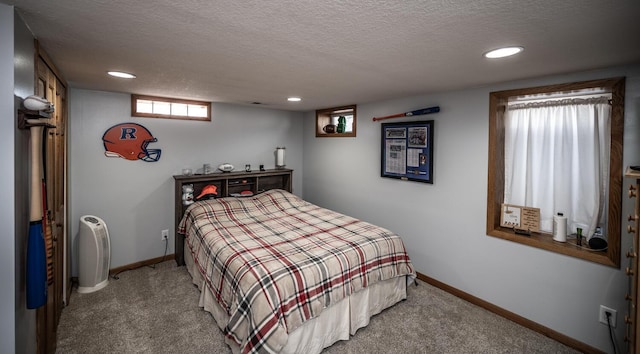 bedroom with recessed lighting, carpet floors, and a textured ceiling