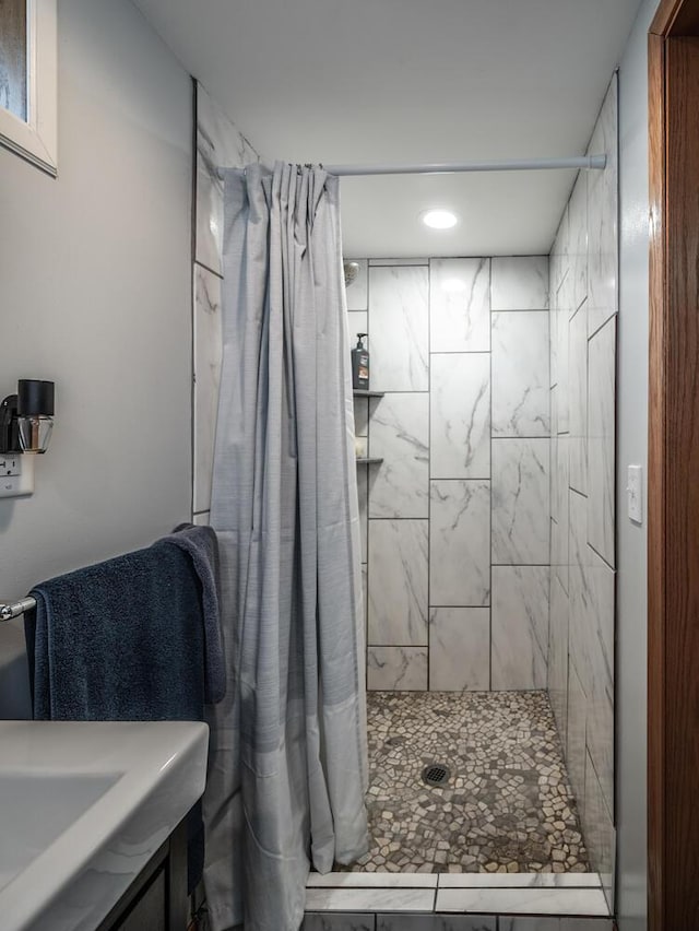 bathroom with vanity, recessed lighting, and tiled shower