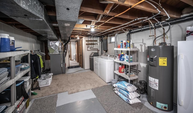 below grade area with electric panel, heating unit, water heater, and independent washer and dryer
