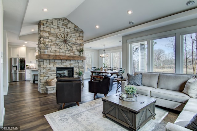 living room featuring a notable chandelier, dark wood-style floors, lofted ceiling, and recessed lighting