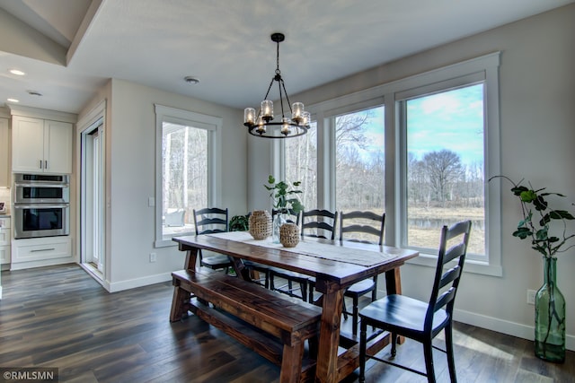 dining space featuring baseboards, recessed lighting, a chandelier, and a healthy amount of sunlight