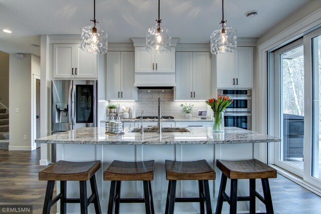 kitchen with dark wood finished floors, visible vents, backsplash, and appliances with stainless steel finishes