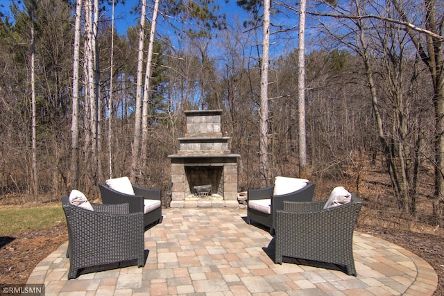 view of patio with an outdoor stone fireplace