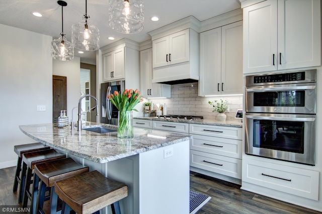 kitchen featuring a sink, appliances with stainless steel finishes, recessed lighting, and dark wood-style floors
