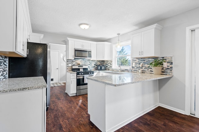 11345 Brenda Blvd, Becker, MN 55308 - kitchen with stainless steel appliances, a peninsula, dark wood-style flooring, white cabinets, and a textured ceiling