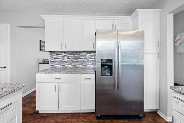 11345 Brenda Blvd, Becker, MN 55308 - kitchen featuring stainless steel fridge, backsplash, dark wood finished floors, light stone countertops, and white cabinetry