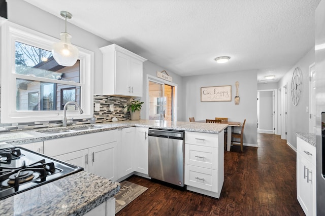 11345 Brenda Blvd, Becker, MN 55308 - kitchen featuring dishwasher, a sink, a peninsula, a textured ceiling, and backsplash