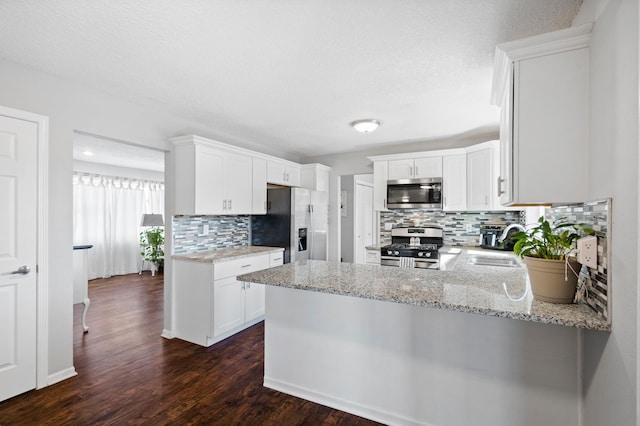 11345 Brenda Blvd, Becker, MN 55308 - kitchen with stainless steel appliances, backsplash, a sink, a peninsula, and light stone countertops