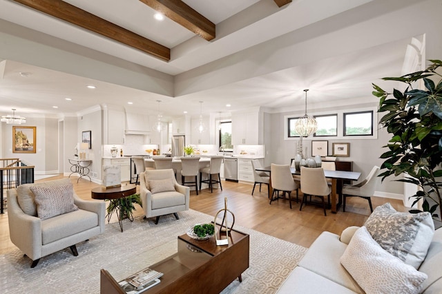 living room with recessed lighting, baseboards, a chandelier, beamed ceiling, and light wood finished floors