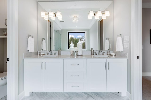 full bathroom with double vanity, a sink, toilet, and a shower stall