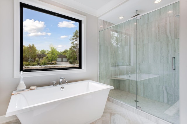 bathroom with a freestanding tub, ornamental molding, a stall shower, and recessed lighting