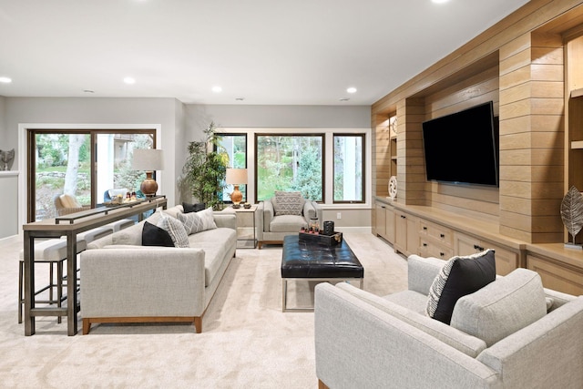 living room with a healthy amount of sunlight, recessed lighting, and light colored carpet