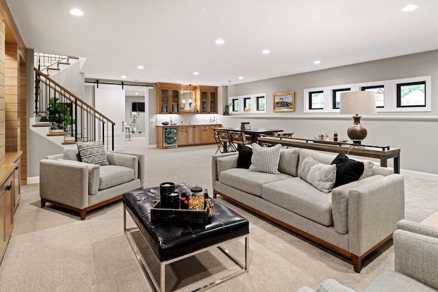 living area featuring stairs, recessed lighting, wine cooler, a barn door, and indoor wet bar